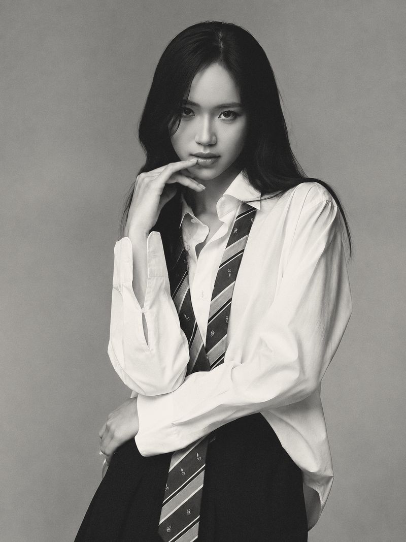 Ta Phuong Linh in an oversized white shirt and striped tie, studio portrait