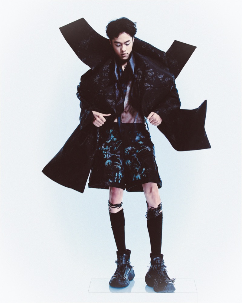 Look C with the brocade coat held open, the architectural shoulder at full span.