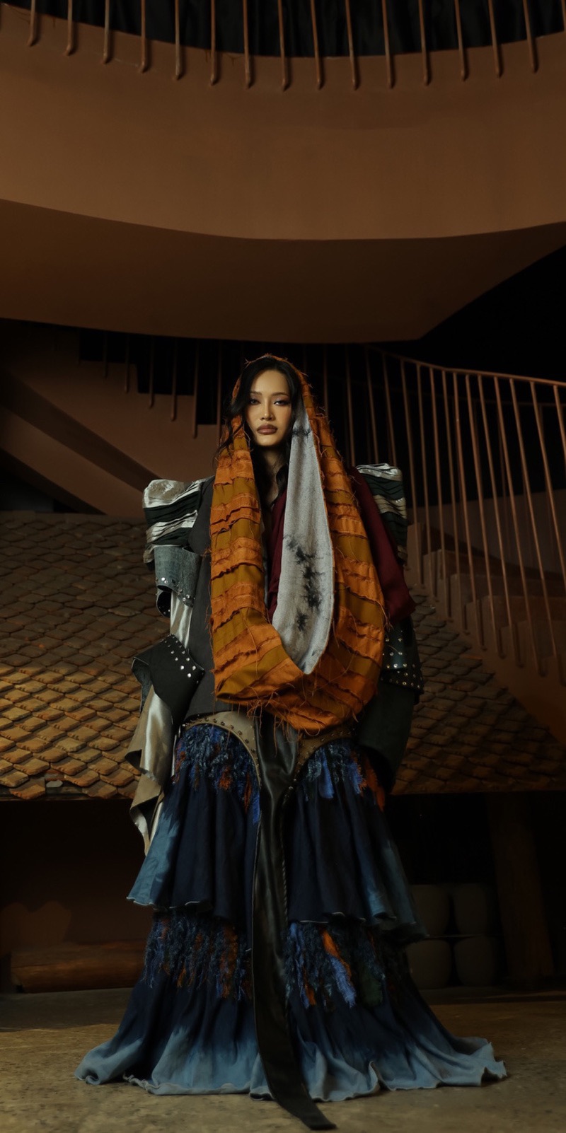 Standing full length on the staircase in an orange hood scarf