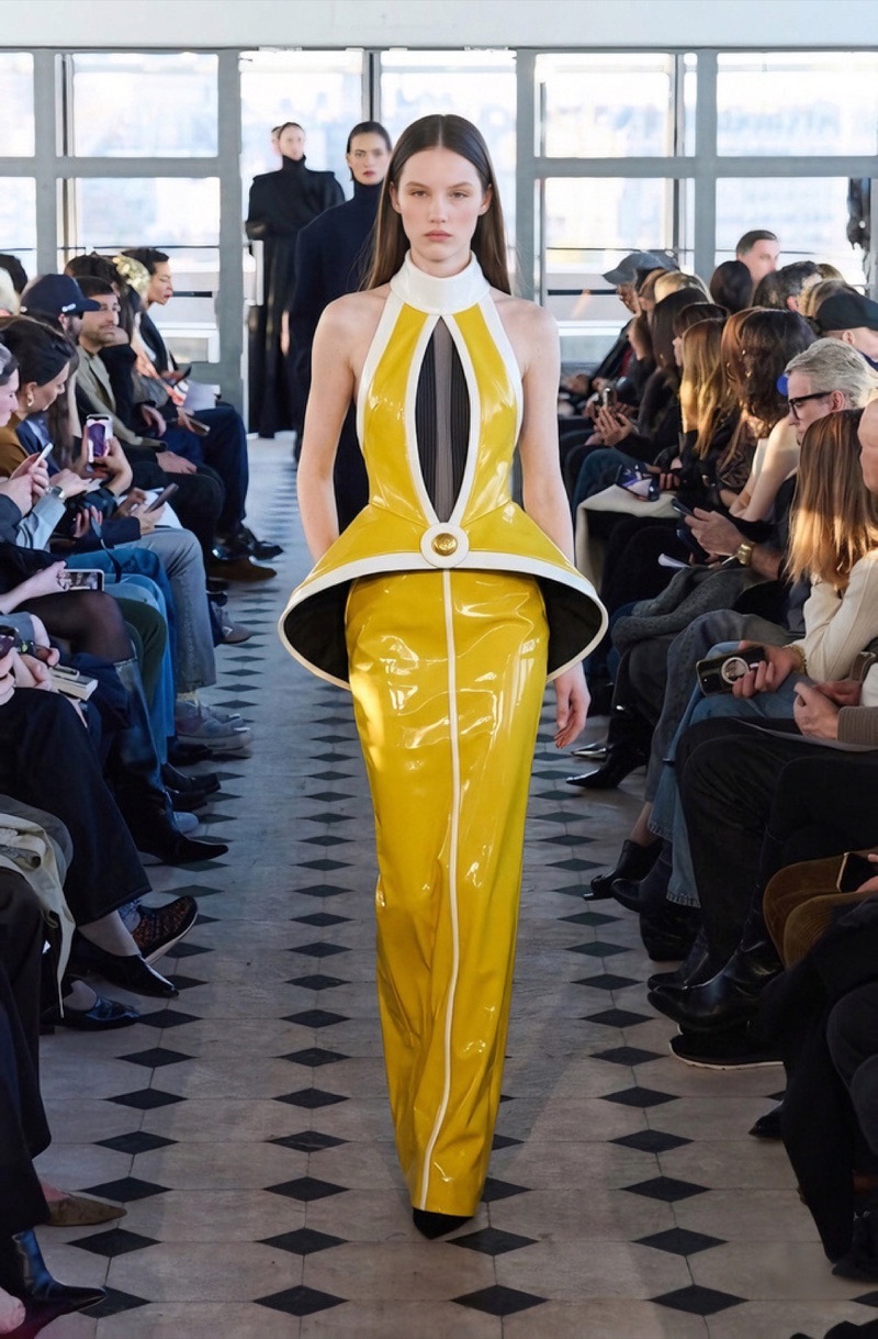 AI runway look in yellow patent leather with a flared peplum ring